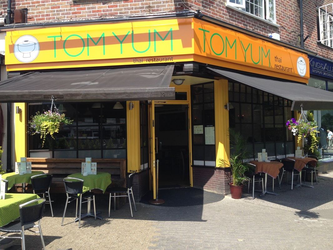 The yellow Tom Yum shopfront on Sycamore Road, with tables outside